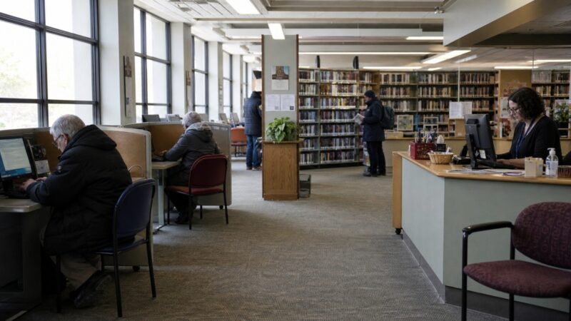 Patrons and a librarian inside a Canadian public library